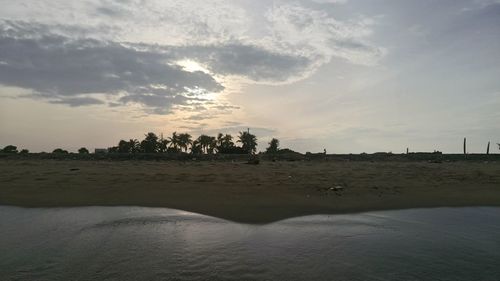 View of calm beach at sunset