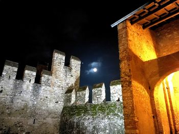 Low angle view of illuminated building at night