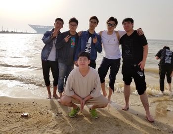 People standing on beach against sky