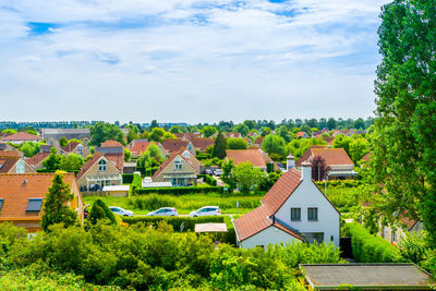 High angle view of houses and buildings against sky