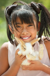 Portrait of cute girl smiling with a rabbit 