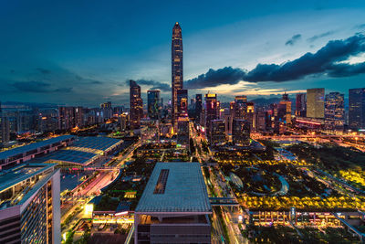 Illuminated buildings in city against sky