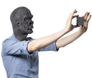 Portrait of man standing against white background