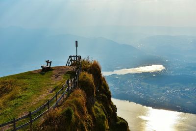 Scenic view of sea and mountains against sky