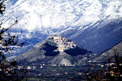 High angle view of townscape and snowcapped mountains