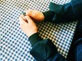 Cropped hands of woman on table