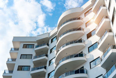 Low angle view of an apartment building with balconies. residential real estate.