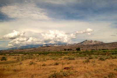 Scenic view of mountains against cloudy sky