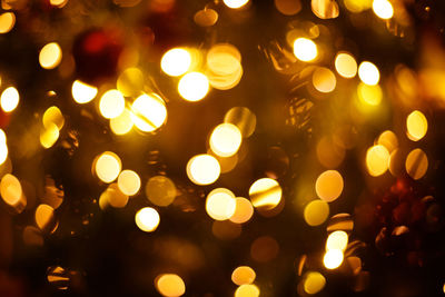 Defocused image of illuminated christmas lights at night