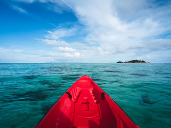 First person view of kayak head to small island. float on turquoise sea. koh lipe island, thailand.