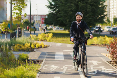 Young man riding bicycle on road