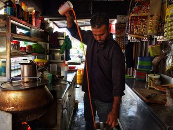 Midsection of man preparing food in kitchen