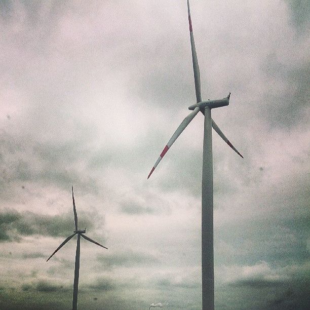 wind turbine, wind power, alternative energy, windmill, environmental conservation, renewable energy, fuel and power generation, low angle view, sky, traditional windmill, technology, cloud - sky, cloudy, rural scene, field, cloud, day, water pump, outdoors, no people