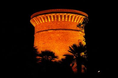 Low angle view of water tower against sky at night