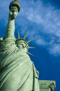 Low angle view of statue against blue sky