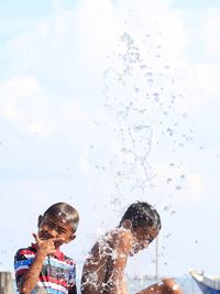 Full length portrait of boy splashing water