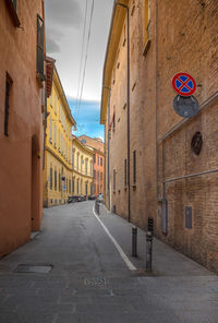 Road amidst buildings against sky