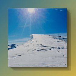 Scenic view of snowcapped landscape against blue sky