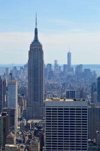 Empire state building against sky at manhattan