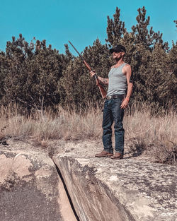 Montana cowboy standing with rifle