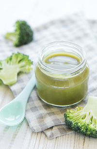 Baby food. organic green broccoli puree with ingredients. mashed broccoli and peas