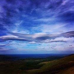 Scenic view of landscape against cloudy sky
