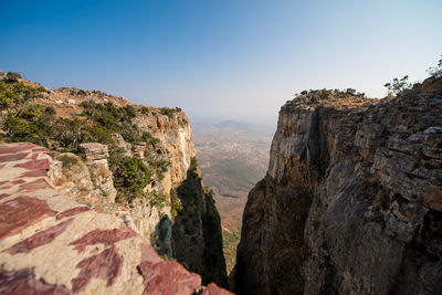 Rock formations on mountain against clear sky