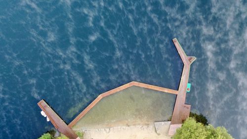 Traditional windmill by swimming pool against sky