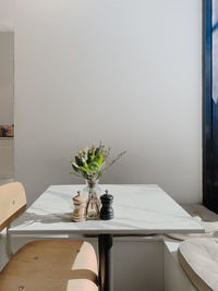 Potted plant on table against wall at home