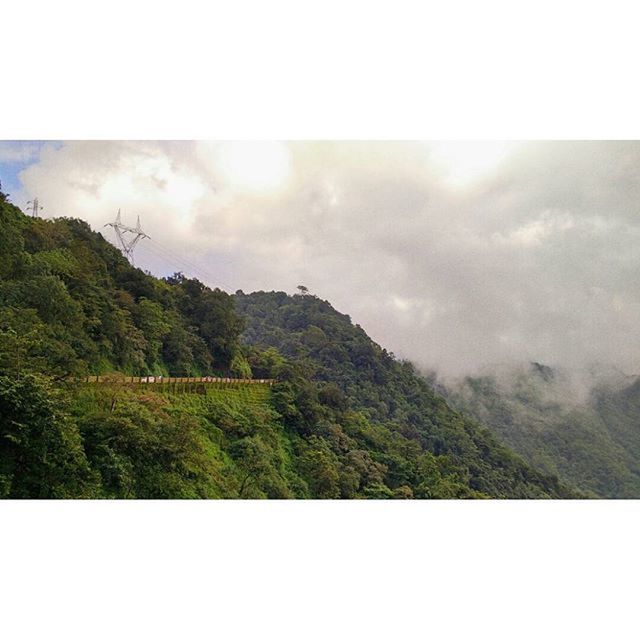 tranquil scene, transfer print, tranquility, scenics, mountain, sky, beauty in nature, landscape, auto post production filter, nature, cloud - sky, tree, mountain range, green color, idyllic, non-urban scene, cloud, cloudy, outdoors, day