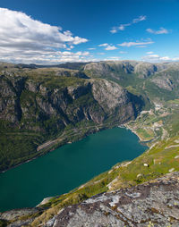 High angle view of lake amidst mountains against sky