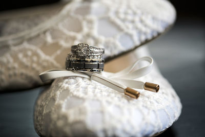 Close up of wedding rings on shoes