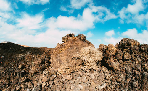 Low angle view of rock formation against sky