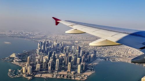 Aerial view of buildings in city against sky