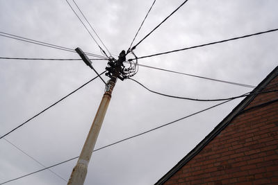 Low angle view of cables against sky