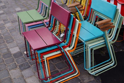 High angle view of empty chairs at sidewalk cafe