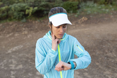 Woman checking pulse rate on smart watch