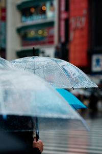 Close-up of raindrops on umbrella in rainy season
