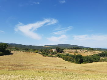 Scenic view of field against blue sky