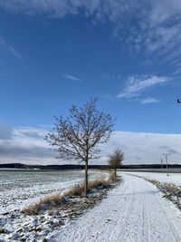 Scenic view of snowy field against sky
