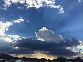 Scenic view of mountains against cloudy sky