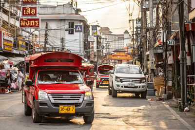 Cars on city street by buildings