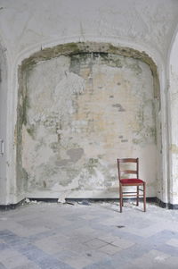 Empty chair in abandoned building