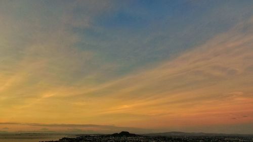 Scenic view of dramatic sky over sea during sunset
