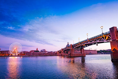 Bridge over river with city in background