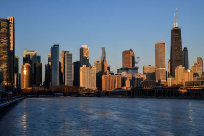 Big city winter skyline along frozen waterfront