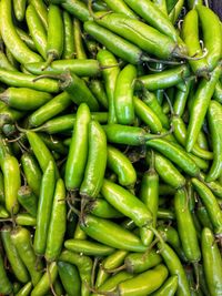 Full frame shot of green chili peppers for sale in market
