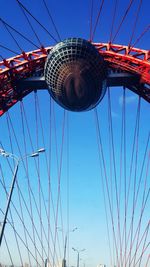 Low angle view of ferris wheel against blue sky