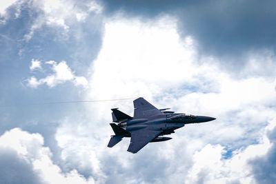 Low angle view of fighter plane flying in sky