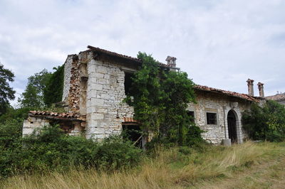 Low angle view of old ruin against sky